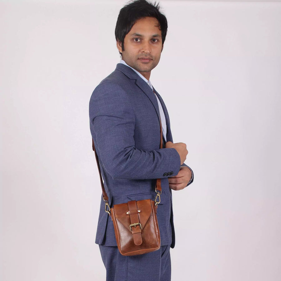 man with tan leather crossbody sling bags