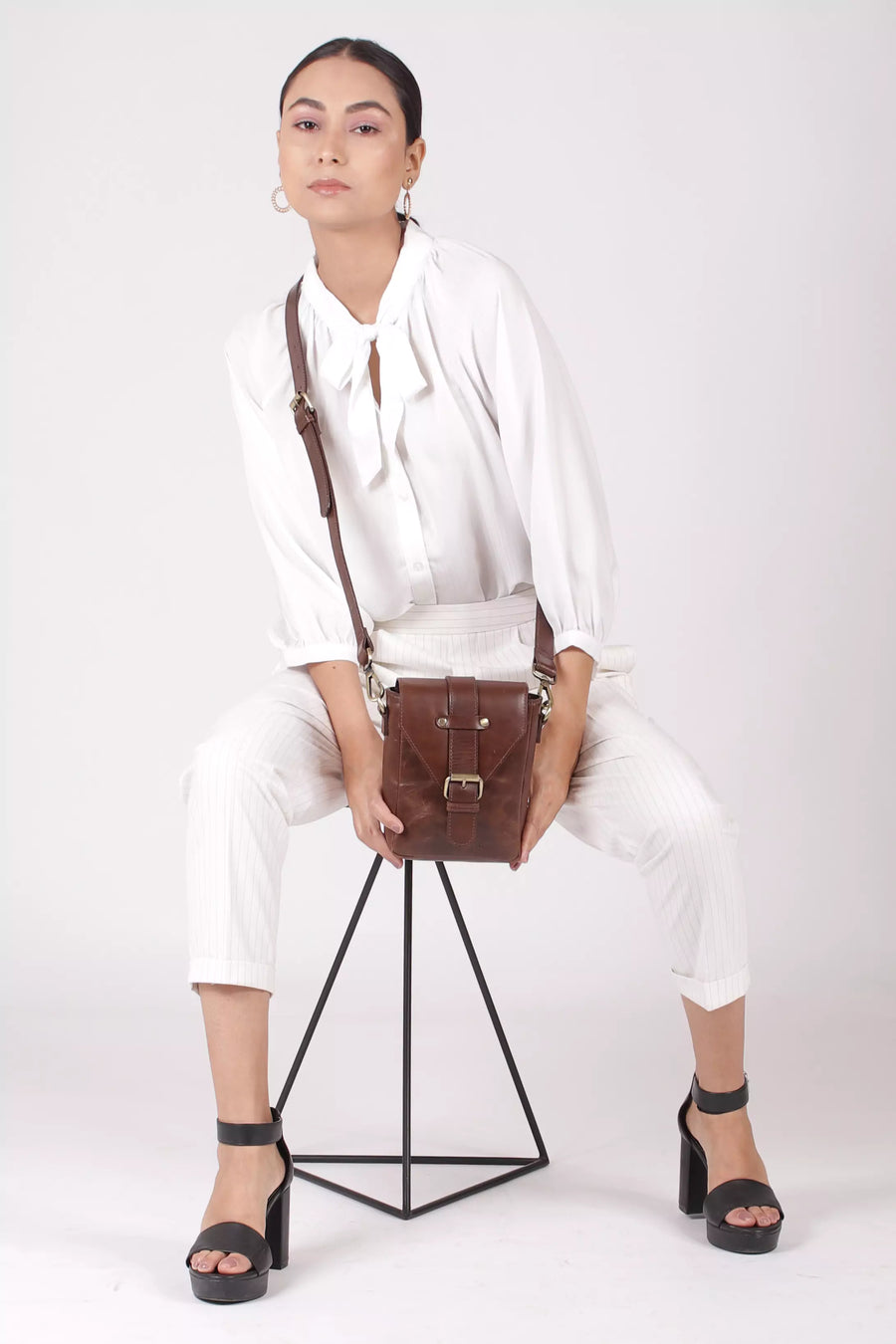 women_with_brown_leather_crossbody_sling_bags